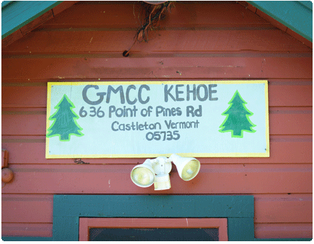 front of camper cabin with Kehoe GMCC sign