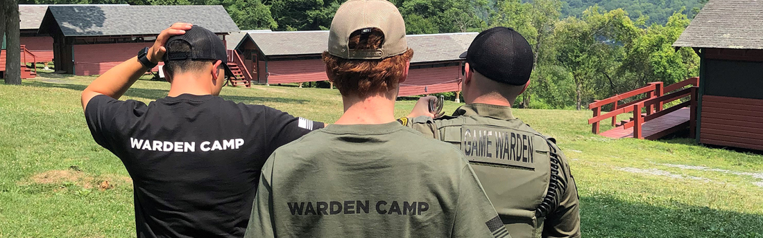 view from behind three people wearing Warden and Warden Camp tops at Kehoe Conservation Camp