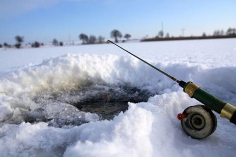 drilled ice fishing hole and fishing pole