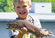 young boy with a rainbow trout