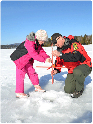 warden with girl ice fishing