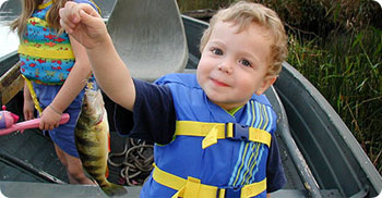 young boy with pan fish