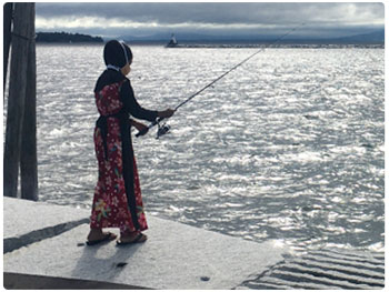 New Americans trying out fishing in Burlington
