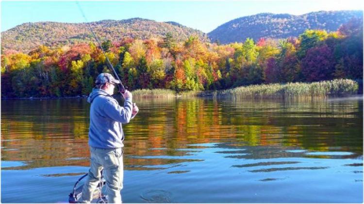 angler fishing during fall peak foliage season