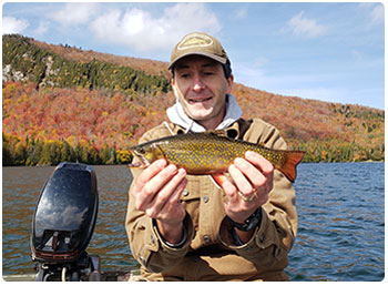 angler with a colorful brook trout