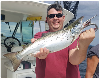 angler with a Lake Champlain salmon