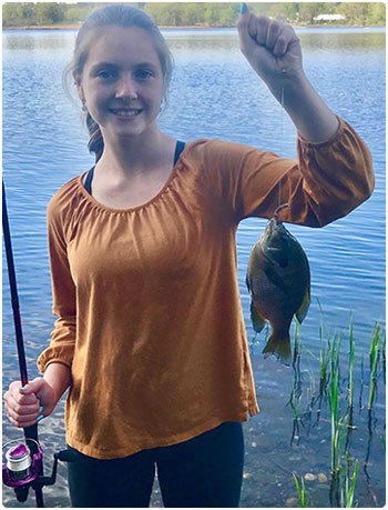 young woman angler with a panfish