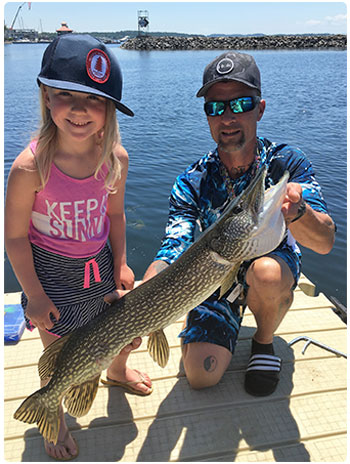 young angler and her dad with a nice pike