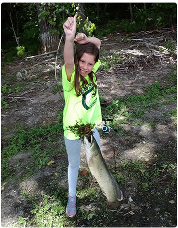 young angler with a bowfin