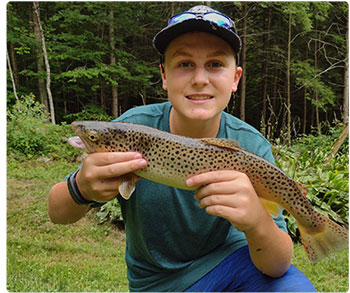 young angler with a beautiful brown trout