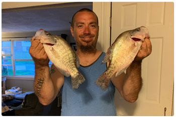 angler show off his catch of crappie
