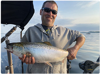 angler with a nice salmon from Lake Champlain