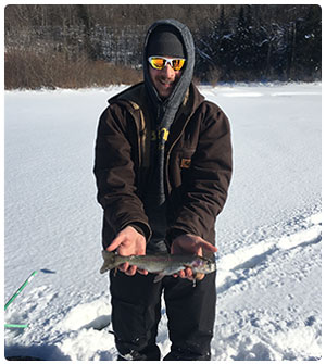 ice angler with rainbow trout