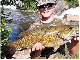 young angler with a bass