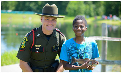 state game warden with a young angler
