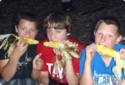 young campers eating corn on the cob