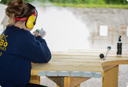 girl shooting at a target at a shooting range