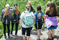 group of girls overlooking a valley