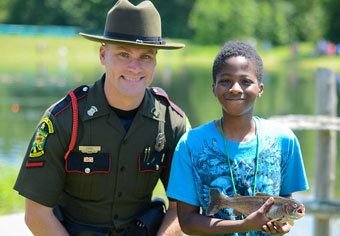 state game warden with young angler