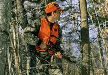 hunter in orange in the woods